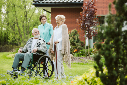 Senior man in a wheelchair on the lawn of a nursing facility
