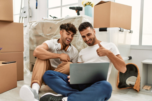 Two new homeowners video chat among the boxes