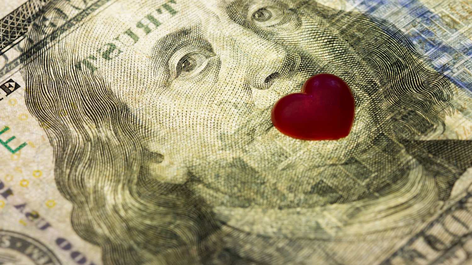 Financial communication represented by Image of US $100 note with heart over Ben Franklin's mouth